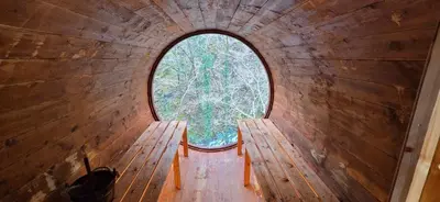 an inside view of a round window in a cabin at Nyth Y Goedwig in Dolgellau