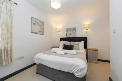 a bedroom with a bed with two pillows on it at The Milking Parlour in Aberystwyth