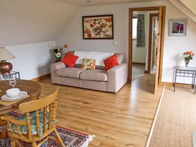 a living room with a couch and a table at Rhiastyn Barn in Hyssington