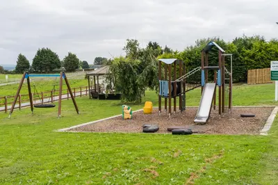 a park with a playground with a swing set at The Stores in Aberystwyth