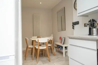 a kitchen and dining room with a table and chairs at Rose Cottage in Shrewsbury