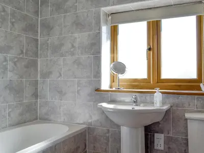 a bathroom with a sink and a tub and a mirror at Upper Close - Uk10873 in Evenjobb