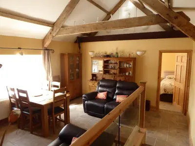 a living room with a couch and a table at Rhydgaled in Llanon