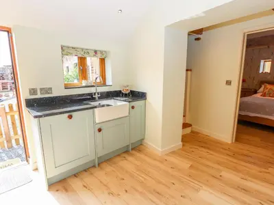 a kitchen with a sink and a mirror at The Tractor Shed in Oswestry