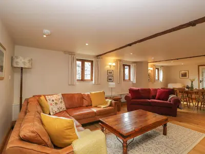 a living room with a couch and a table at The Old Barn in Hereford