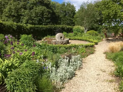 a garden with a bird bath in the middle at The Granary in Hereford