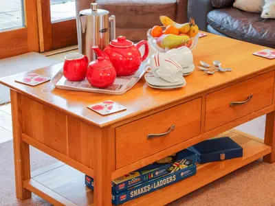 a wooden coffee table with a bowl of fruit on it at Southdown in Much Wenlock