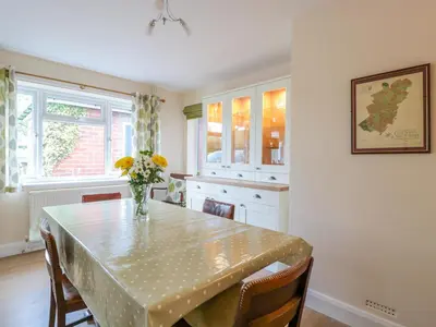a kitchen with a table with a vase of flowers on it at Bower View in Hereford