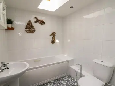a bathroom with a tub and a sink and a toilet at Bari in Aberaeron