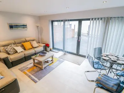 a living room with a couch and a table at 7evern Porth Farm in Caersws
