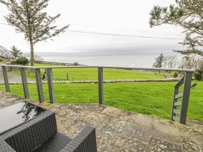 a view of the ocean from the balcony of a house at Hendre Wylan in Barmouth