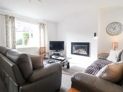 a living room with a couch and a tv at Arnant in Dolgellau