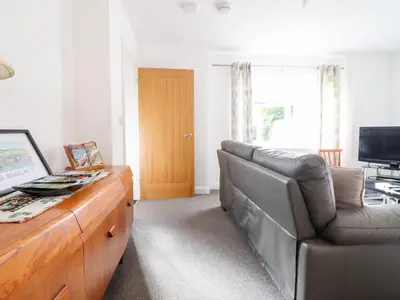 a living room with a couch and a chair at Arnant in Dolgellau