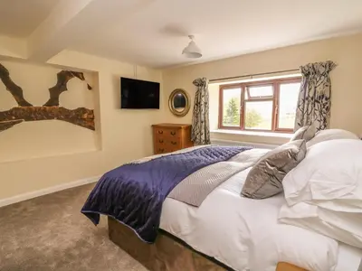 a bedroom with a bed and a window at Treboeth in Knighton