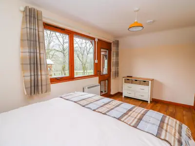 a bedroom with a bed and a window at Pines Pitch in Knighton