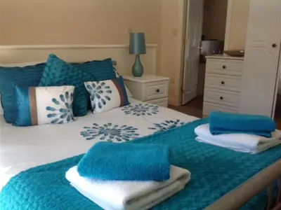 a blue and white bed with towels on it at The New Inn in Oswestry