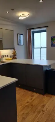 a kitchen with a large counter and a window at Luxury Sea View Apartment - One Bedroom in Aberystwyth