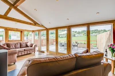 a living room with leather furniture and large windows at 4 Bed in Bala oc-bow66 in Bala