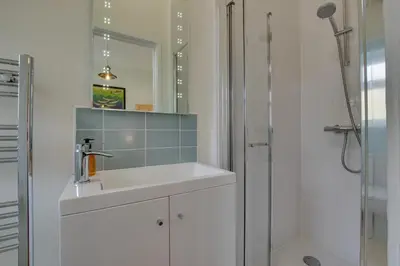 a white bathroom with a sink and a shower at 3 Bed in Aberystwyth oc-bow115 in Aberystwyth