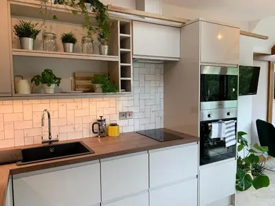 a kitchen with white cabinets and a sink at The Folly in Ludlow