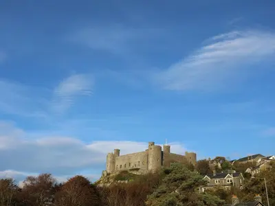 a castle sitting on top of a hill at Harlech Apartments - Branwen in Harlech