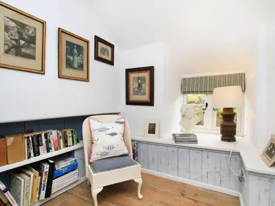 a chair in a room with a desk and a window at Big House in Llandecwyn
