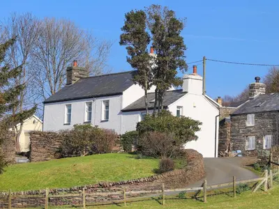 a white house with a tree in front of it at Big House in Llandecwyn