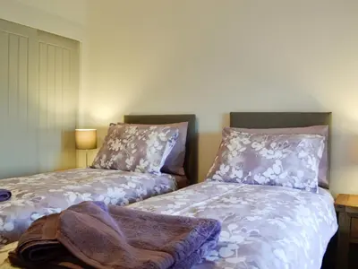two beds sitting next to each other in a bedroom at Pistyll Gwyn in Llanwrthwl