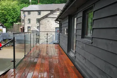 a wooden deck on the side of a building at The Coach House Annexe in Llangollen