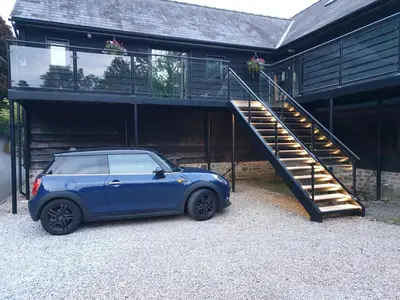 a small blue car parked in front of a house at The Coach House Annexe in Llangollen