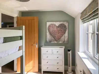a bedroom with a heart painting on the wall at Brynich Villa in Brecon