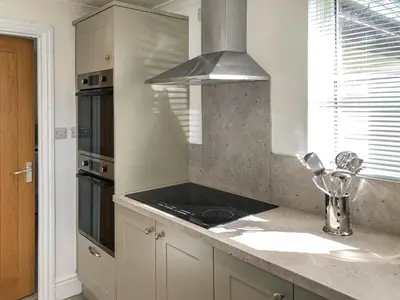a kitchen with a sink and a stove at Brynich Villa in Brecon