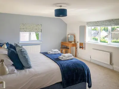 a bedroom with a bed with two towels on it at Brynich Villa in Brecon