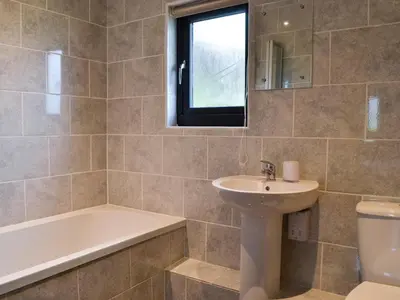 a bathroom with a sink and a tub and a toilet at Offa's Dyke Lodge - Uk10835 in Old Radnor
