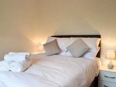 a bedroom with a white bed with towels on it at Offa's Dyke Lodge - Uk10835 in Old Radnor
