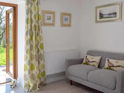 a living room with a couch and a window at Parlwr - Uk11210 in Cwrt-newydd