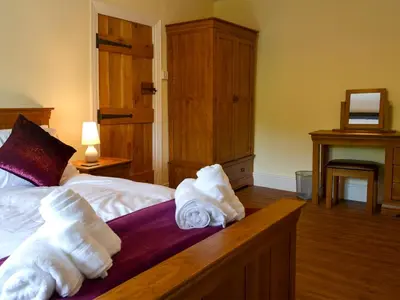 a hotel room with towels on a bed at Tyddyn Eli in Llangwm