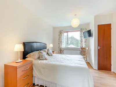 a bedroom with a bed and a dresser and a window at Cambrian Mountain View in Llanafan-fawr