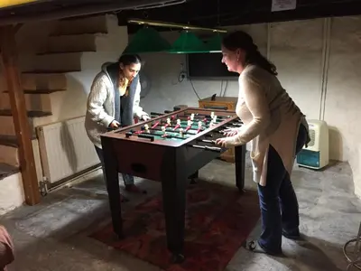 two women playing a game of chess on a table at Cynfaen house in Corwen