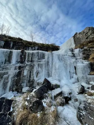 a frozen waterfall on the side of a mountain at Tegfan Garden Suite in Talgarth