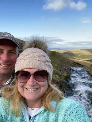 a man and a woman standing next to a river at Tegfan Garden Suite in Talgarth