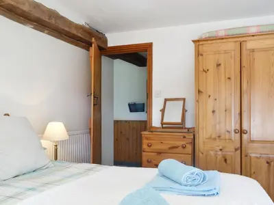 a bedroom with a bed and a dresser and a mirror at Mountain View-Uk11825 in Llandefaelogfâch