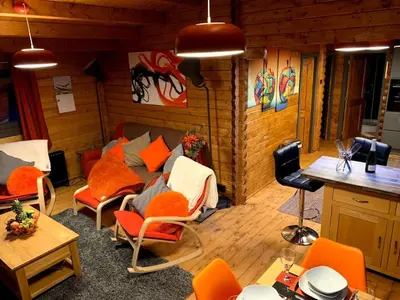 a living room with orange chairs and a couch at Long Wood Lodges in Knighton