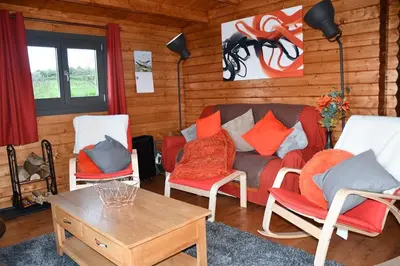 a living room with chairs and a couch and a table at Long Wood Lodges in Knighton