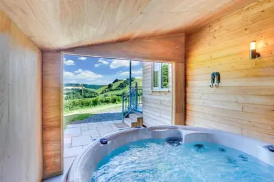 a bath tub in a room with a large window at 1 Bed in Lower Chapel oc-waa396 in Lower Chapel