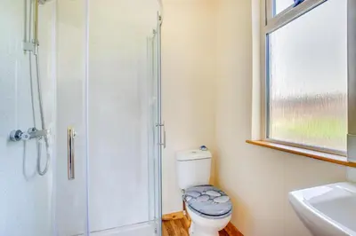a bathroom with a toilet and a shower and a sink at 1 Bed in Lower Chapel oc-waa396 in Lower Chapel