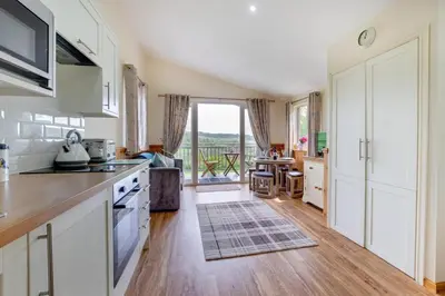 a kitchen with white cabinets and a large window at 1 Bed in Lower Chapel oc-waa906 in Lower Chapel