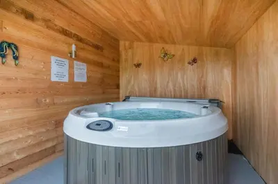 a sauna with a hot tub in a wooden room at 1 Bed in Lower Chapel oc-waa906 in Lower Chapel