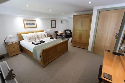 a bedroom with a large bed in a room at Rhydyfran House Aberaeron, Lampeter, West Wales, Ceredigion in Lampeter