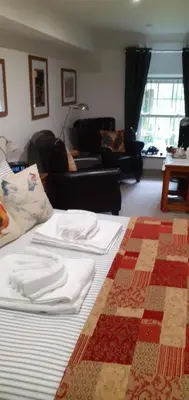 a bedroom with a bed with white towels on it at Rhydyfran House Aberaeron, Lampeter, West Wales, Ceredigion in Lampeter